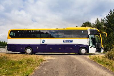 Bus of Monbus parked on the side of the road.
